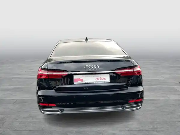 Das Bild zeigt die Rückansicht eines schwarzen AUDI A6. Es enthält das Händlerlogo.
