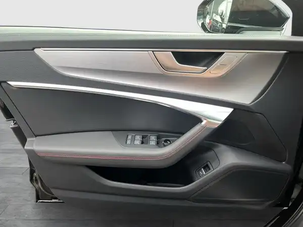Innenaufnahme des AUDI A6 mit schwarzem Interieur und silbernen Akzenten an der Tür.