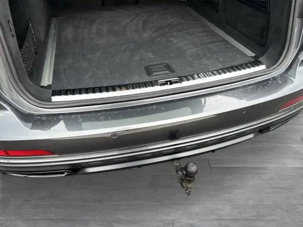 Das Bild zeigt den Kofferraum eines grauen AUDI A6 Avant aus der Rückansicht.