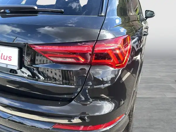Das Bild zeigt eine Rückansicht eines schwarzen AUDI Q3.