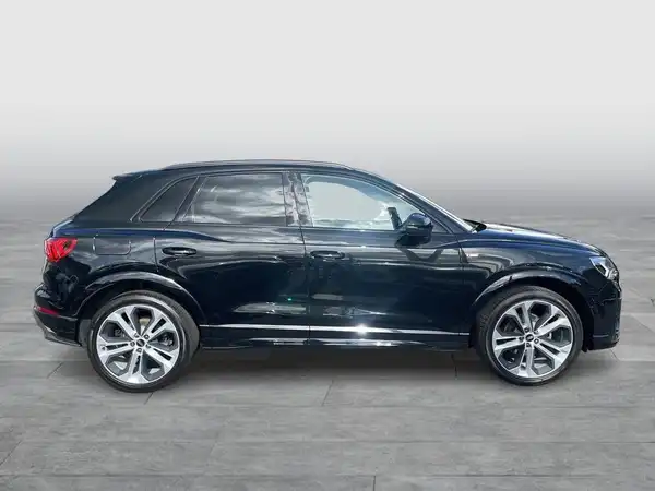 Das Bild zeigt einen schwarzen Audi Q3 aus der Seitenansicht.