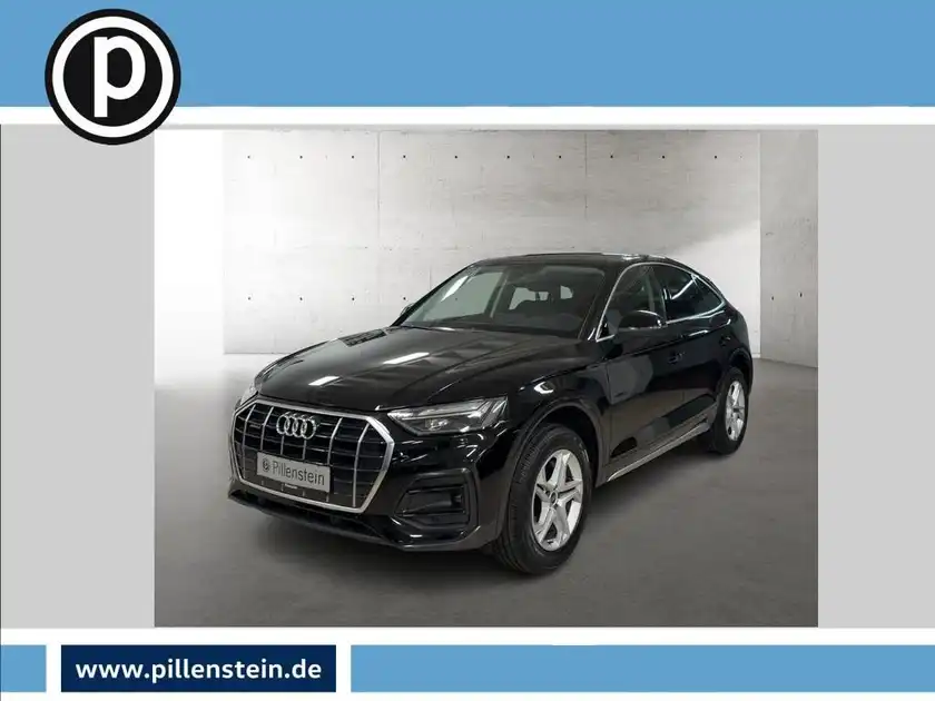 Das Bild zeigt einen schwarzen Audi Q5, aufgenommen von vorne. Das Händlerlogo ist eingeblendet und es gibt markante Texteinblendungen aus der Anzeige.