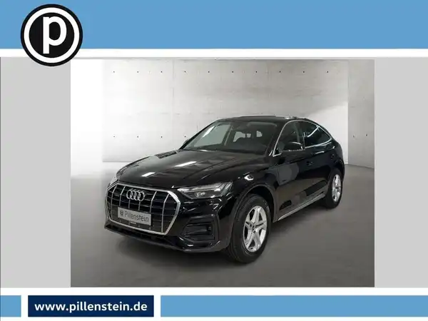 Das Bild zeigt einen schwarzen Audi Q5, aufgenommen von vorne. Das Händlerlogo ist eingeblendet und es gibt markante Texteinblendungen aus der Anzeige.