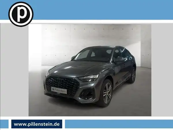 Das Bild zeigt ein graues Fahrzeug (Audi Q5) von vorne. Es enthält das Händlerlogo und markante Texteinblendungen.