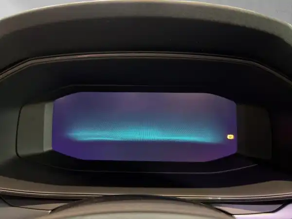 Das Bild zeigt das Innere des Fahrzeugs, speziell das digitale Armaturenbrett in Schwarz.