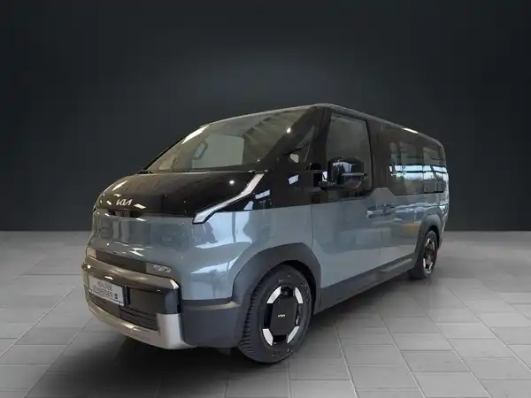 Das Bild zeigt einen KIA PV5 PASSENGER von der Seite in einer blau-grauen Farbe.
