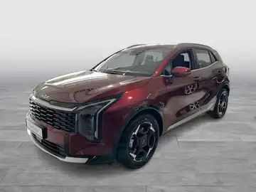 Das Bild zeigt einen KIA SPORTAGE von der Seite in einer roten Farbe. Es handelt sich um ein Fahrzeugbild.