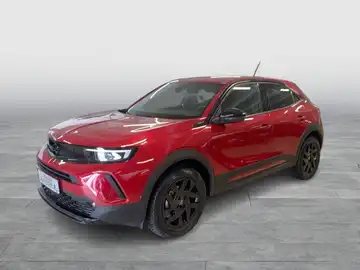 Das Bild zeigt ein rotes Fahrzeug (OPEL MOKKA) aus der Seitenansicht. Im unteren Bereich des Bildes ist das Händlerlogo 'WALTER SCHNEIDER' sowie weitere Logoelemente sichtbar.