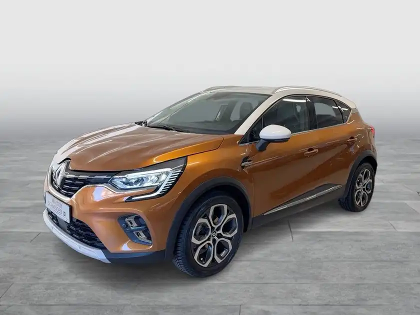 Das Bild zeigt einen Renault Captur aus seitlicher Perspektive in orange.