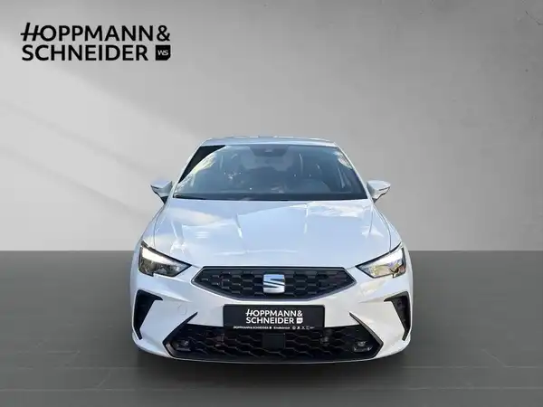 Das Bild zeigt einen weißen SEAT IBIZA aus der Frontansicht mit dem Händlerlogo von HOPPMANN & SCHNEIDER.