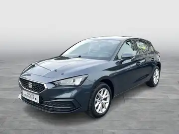 Das Bild zeigt einen schwarzen SEAT LEON von der Seite. Es ist ein Fahrzeugbild, auf dem ein Händlerlogo sichtbar ist.
