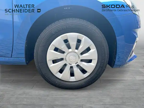 Das Bild zeigt die rechte Seite des blauen ŠKODA FABIA, wobei ein Teil des Rades sichtbar ist. Im Bild sind das Händlerlogo von Walter Schneider und der Schriftzug SKODA Plus zu sehen.