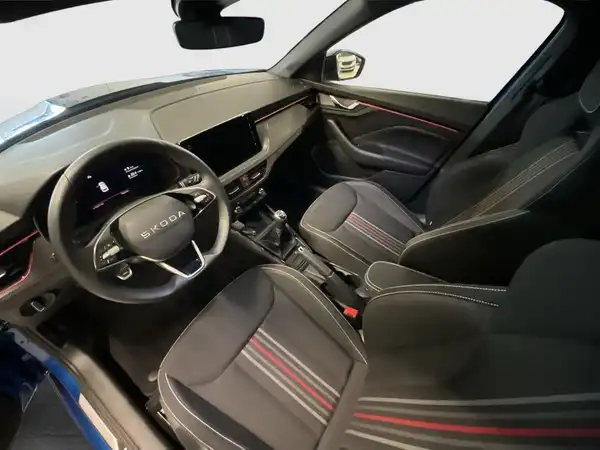Das Bild zeigt den Innenraum eines ŠKODA KAMIQ mit schwarzen Sitzen und gestreiften Akzenten.