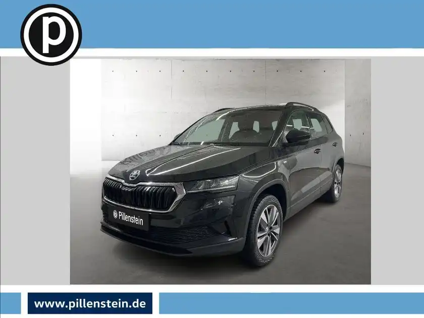 Das Bild zeigt einen schwarzen ŠKODA KAROQ aus der Frontansicht mit dem Händlerlogo 'Pillenstein'.