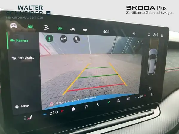 Innenaufnahme des Fahrzeugs mit einem Display für Rückfahrkamera und Park Assist, das Händlerlogo ist sichtbar.