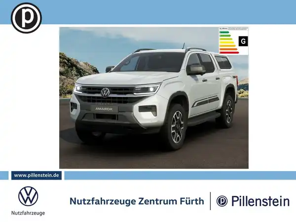 Das Bild zeigt einen weißen VW Amarok, aufgenommen von vorne. Auf dem Bild ist das Händlerlogo von Pillenstein sowie markante Texteinblendungen sichtbar.