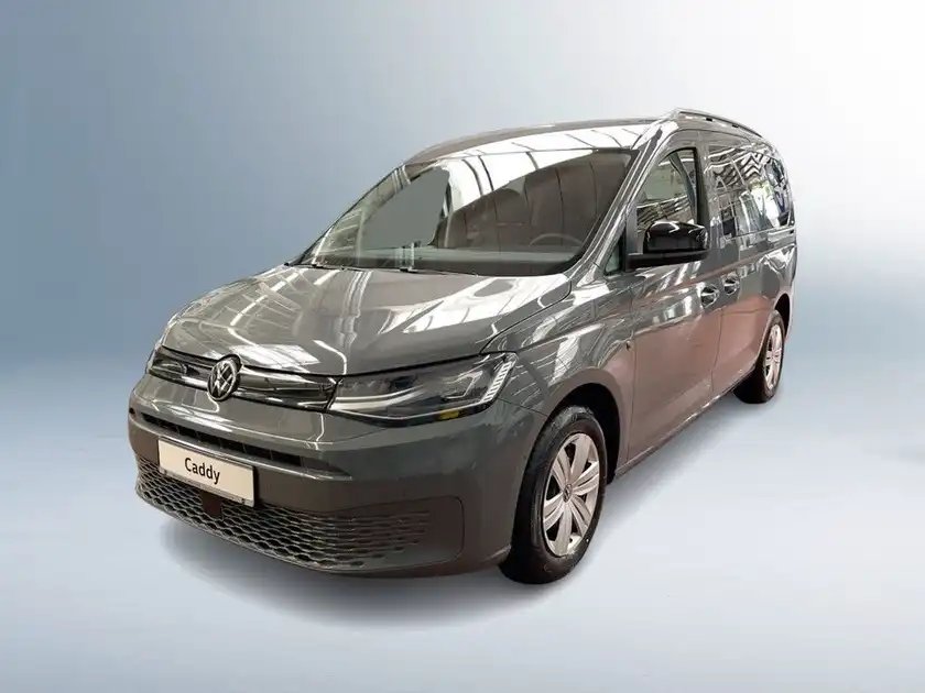 Das Bild zeigt einen grauen VW Caddy von vorne. Es sind Texteinblendungen auf dem Bild vorhanden.