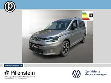 Das Bild zeigt einen grauen VW Caddy aus der Seitenansicht. Im Bild ist das Händlerlogo von Pillenstein zu sehen, sowie markante Texteinblendungen.