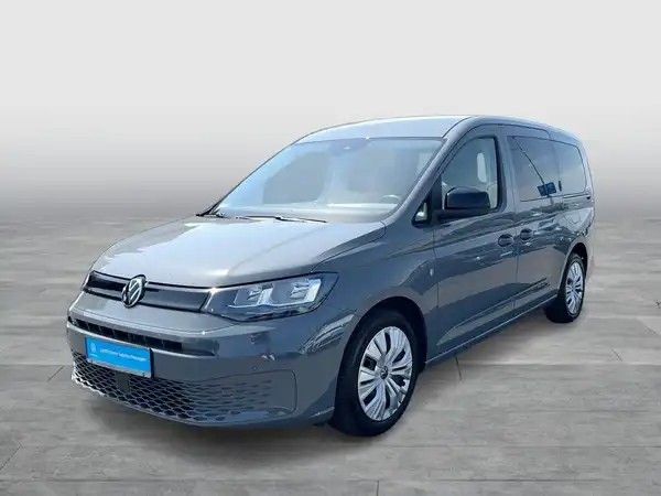Das Bild zeigt einen grauen VW Caddy von vorne. Das Händlerinformationen sind im unteren Bereich des Bildes sichtbar.