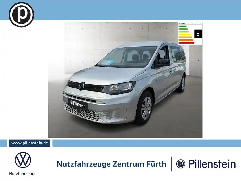Das Bild zeigt einen silbernen VW Caddy von der Seite. Es enthält das Händlerlogo und markante Texteinblendungen.