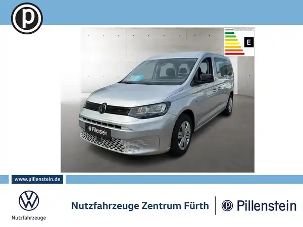 Das Bild zeigt einen silbernen VW Caddy von der Seite. Es enthält das Händlerlogo und markante Texteinblendungen.
