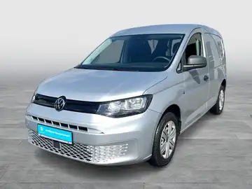 Foto zeigt einen silbernen VW Caddy Kasten aus der Vorderansicht, mit Händlerlogo und Texteinblendungen.