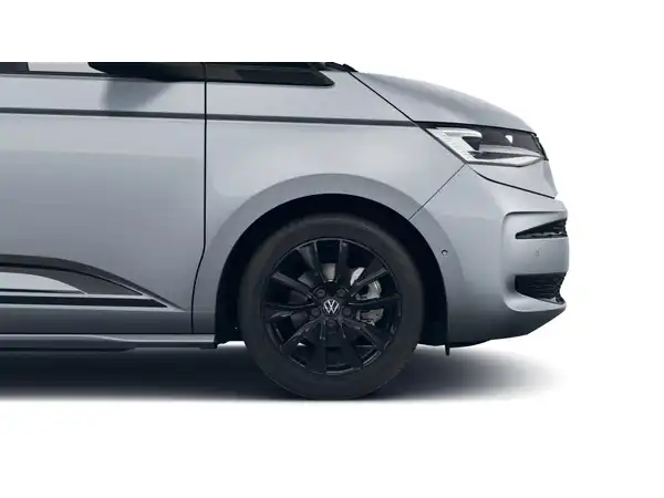 Das Bild zeigt einen VW Multivan von der Seite in silberner Farbe.