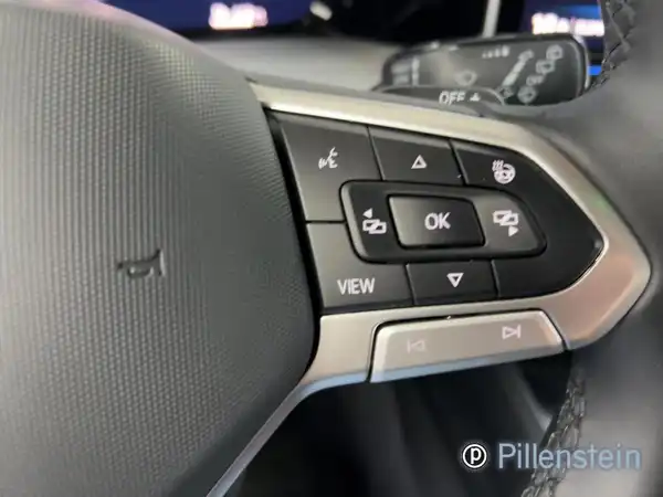 Das Bild zeigt eine Innenaufnahme des VW Golf Variant mit dem Fokus auf das Lenkrad und Bedienelemente. Die Interieurfarbe ist schwarz.