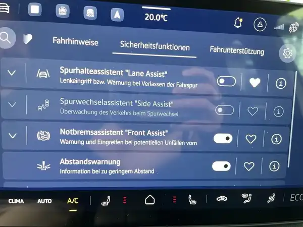 Das Bild zeigt das Innenlayout eines VW ID.3 mit einem Fokus auf das zentrale Display. Es sind Sicherheitsfunktionen wie Spurhalteassistent, Notbremsassistent und Abstandswarner aufgelistet.