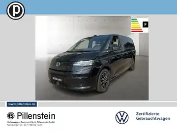 Das Bild zeigt einen schwarzen VW Multivan von der Seite. Es ist ein Fahrzeugbild mit Händlerlogo und Textmarkierung.