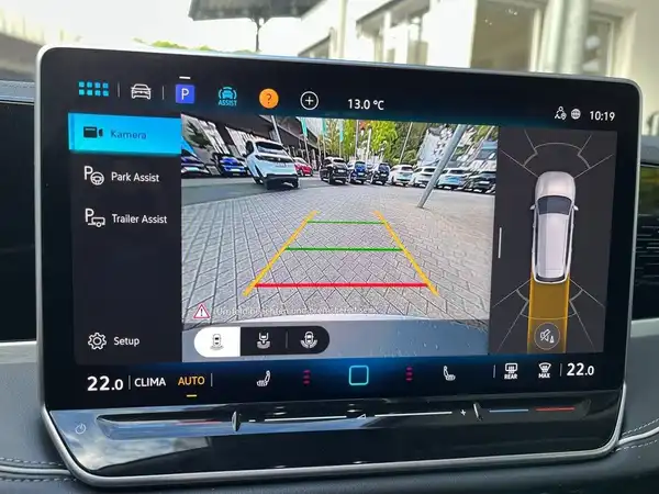 Innenaufnahme des Fahrzeugs zeigt das Navigationssystem mit Rückfahrkamera und Assistenzfunktionen.