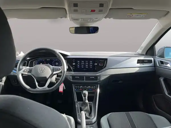 Das Bild zeigt das Inneninterieur eines VW Polo in schwarz mit silbernen Akzenten. Es handelt sich um eine Innenaufnahme des Fahrzeugs.
