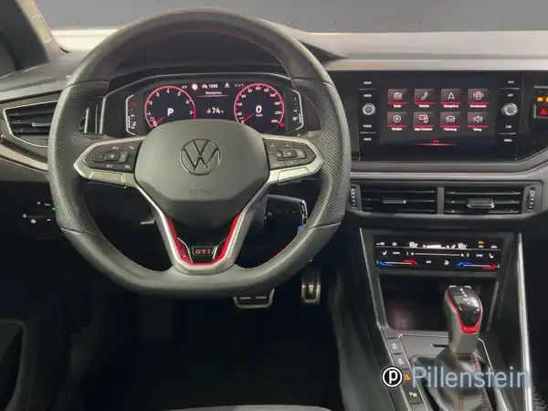Innenaufnahme des VW Polo GTI, schwarzes Interieur mit roten Akzenten, Händlerinformationen sichtbar.