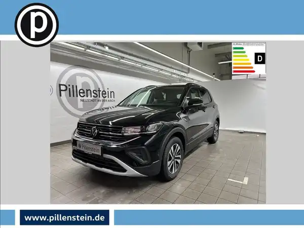 Das Bild zeigt einen schwarzen VW T-CROSS von der Seite in einem Ausstellungsraum. Das Händlerlogo von Pillenstein ist sichtbar, sowie einige markante Texteinblendungen über dem Fahrzeug.