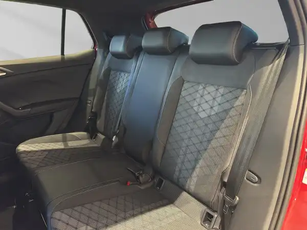 Das Bild zeigt die Rückbank des VW T-CROSS in schwarzem Innenraumdesign mit einem gemusterten Stoff.