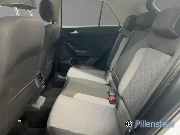 Das Bild zeigt den Innenraum eines VW T-ROC, speziell die Rücksitze. Die Sitze sind in Grautönen gehalten.