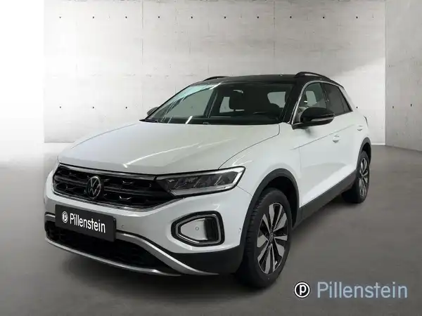 Das Bild zeigt einen weißen VW T-ROC von vorne. Das Händlerlogo 'Pillenstein' ist eingeblendet.