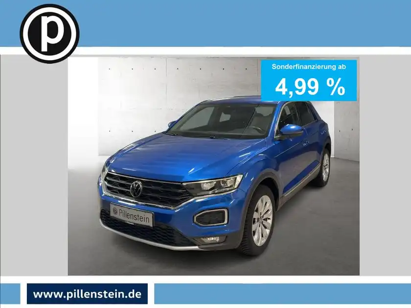 Das Bild zeigt einen blauen VW T-ROC von vorne. Es enthält eine markante Texteinblendung "Sonderfinanzierung ab 4,99 %" und das Händlerlogo ist sichtbar.