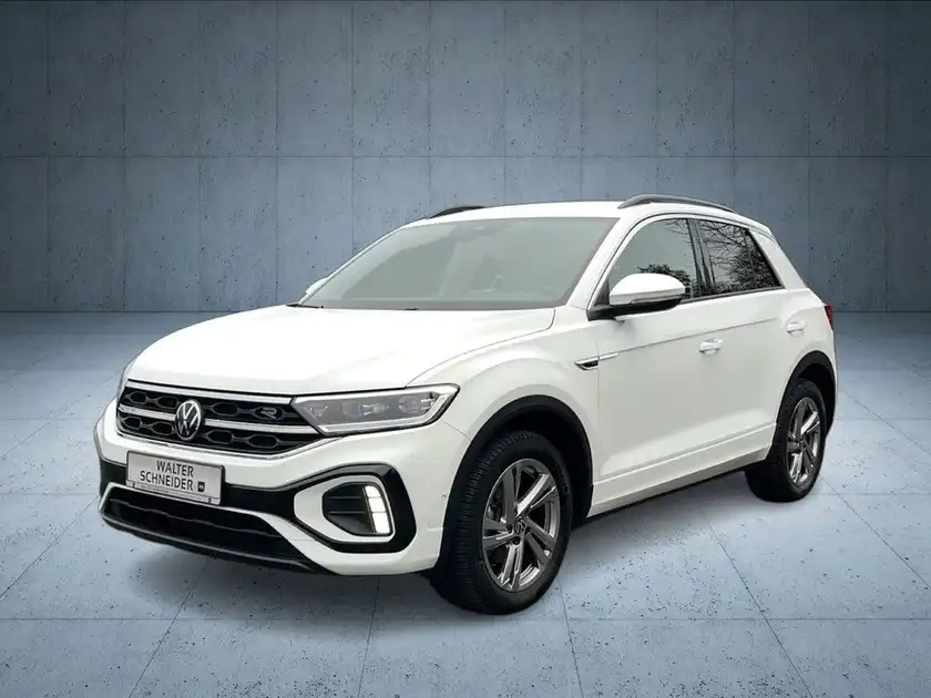 Das Bild zeigt ein weißes Fahrzeug (VW T-ROC) aus der Frontalansicht. Das Händlersymbol von Walter Schneider ist in der unteren Bildhälfte eingeblendet.