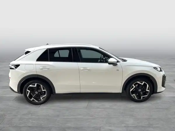Das Bild zeigt einen VW T-ROC aus der Seitenansicht in weiß.