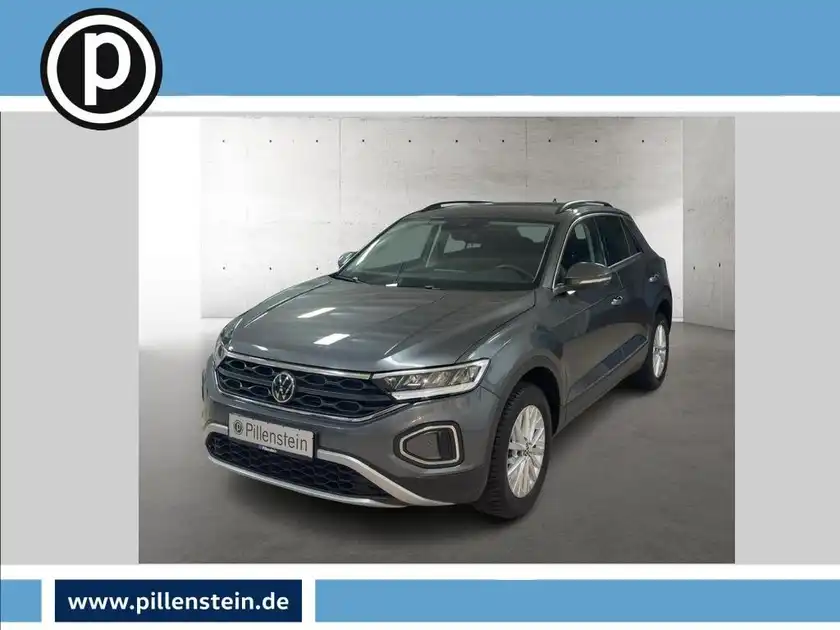 Das Bild zeigt einen grauen Volkswagen T-Roc aus der Frontalansicht. Das Händlerinformationen ist im unteren Bereich des Bildes eingeblendet.
