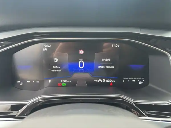 Das Bild zeigt das Armaturenbrett eines VW Taigo mit schwarzem Interieur. Es enthält markante Texteinblendungen auf dem Bildschirm.