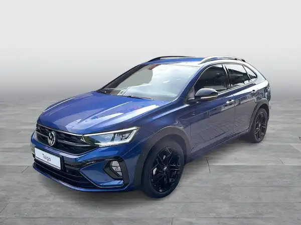 Das Bild zeigt einen VW TAIGO R-Line in blauer Farbe, aufgenommen von der Seite.