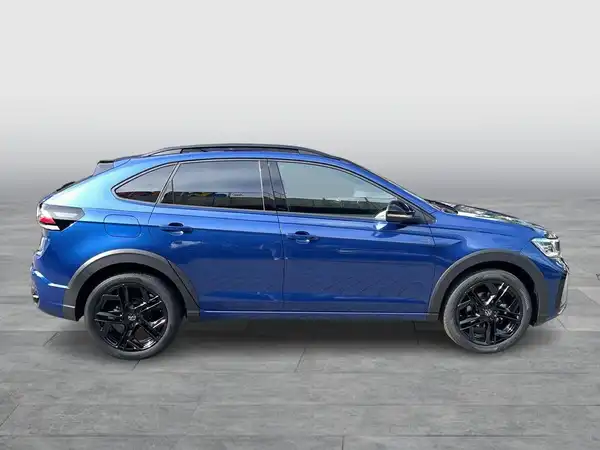Das Bild zeigt einen VW TAIGO R-Line in blauer Lackierung, aufgenommen von der Seite.