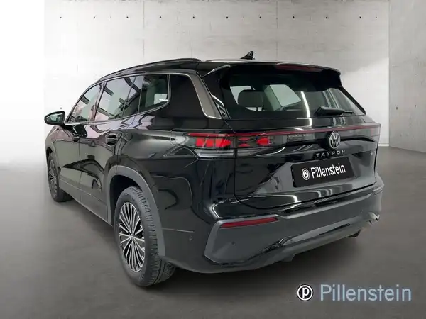 Innenaufnahme eines VW TAYRON mit schwarzem Interieur und sichtbarem Händlerlogo.
