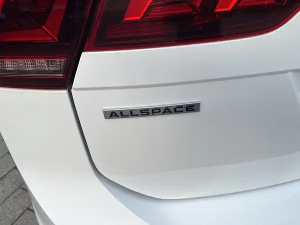 Ein Bild des VW Tiguan Allspace, aufgenommen von hinten. Das Fahrzeug ist weiß.